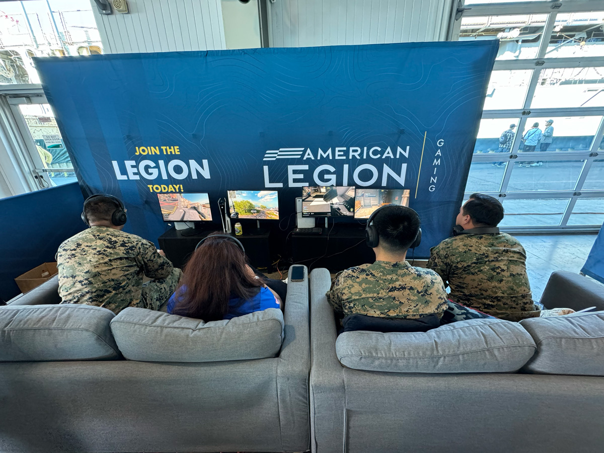 service members sit at an ALG video game lounge set up during San Diego Fleet Week 2024.