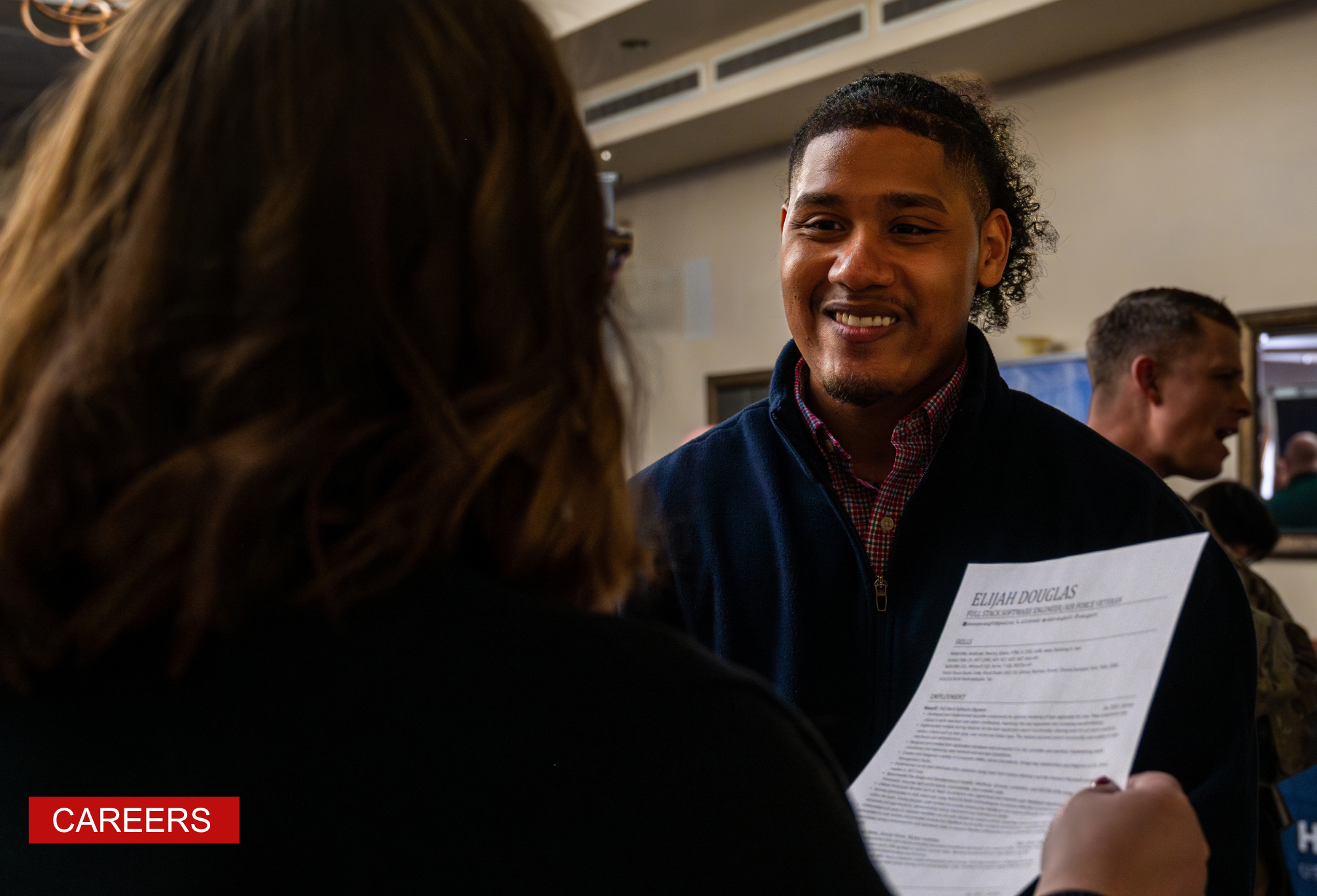 U.S. Air Force Veteran speaks with a recruiter during the Hiring Our Heroes Career Expo at Luke Air Force Base.